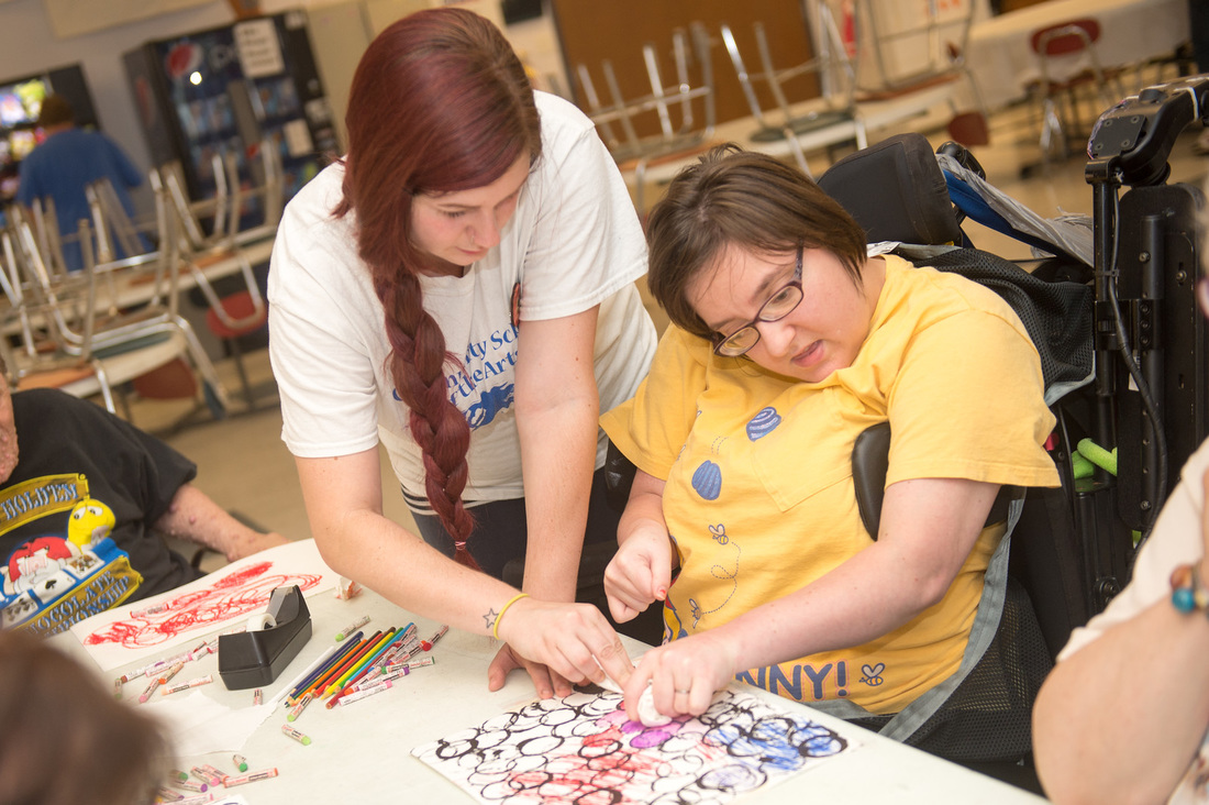 Shayla Fish, a senior art educaton major at Indiana State University, works with developmentally disabled adults at Development Services, Inc. in Terre Haute July 22, 2015 as part of Art for Life, a program offered by the univesity's Community School of the Arts. Photo credit: (ISU/Rachel Keyes)
