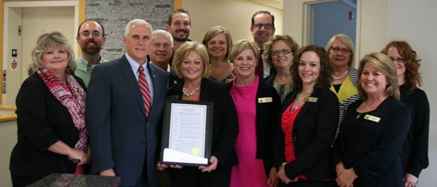 Governor Mike Pence, Opportunity Enterprises CEO Ellen DeMartinis, and staff hold the governor’s proclamation that October is Disability Employment Awareness Month. Photo credit: facebook/oppent